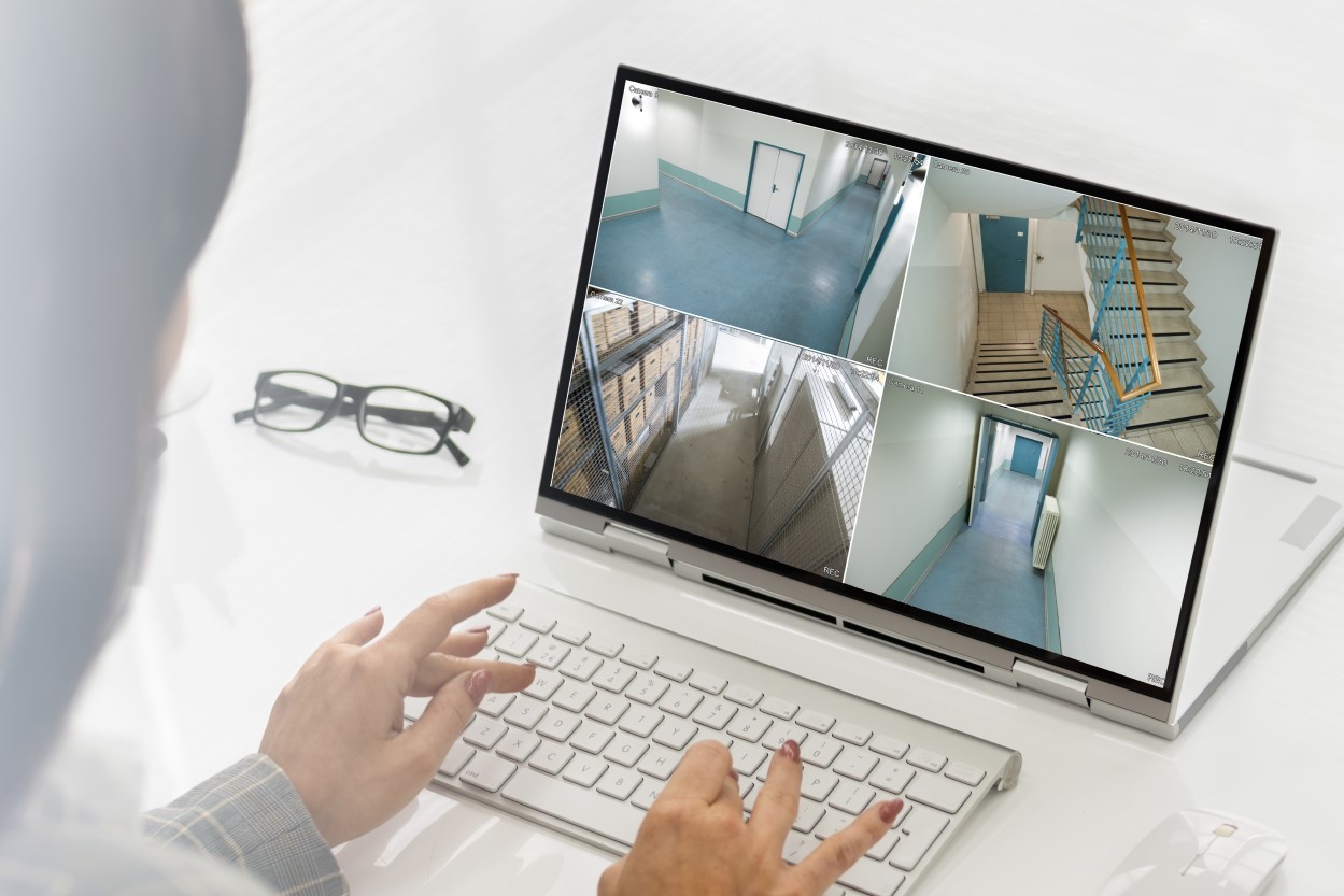 woman monitoring commercial video surveillance system on her tablet.