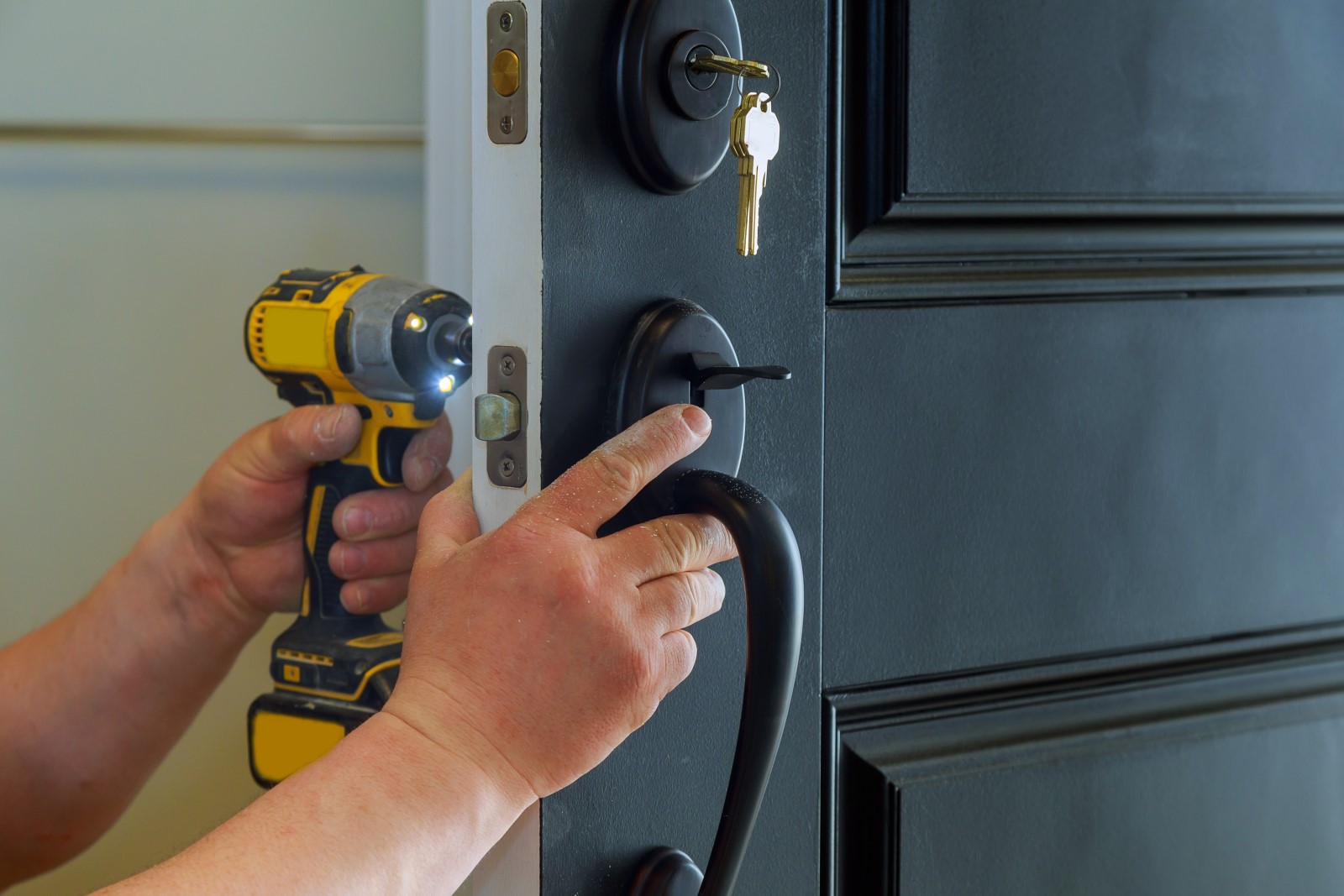 Residential locksmith installing a deadbolt lock.